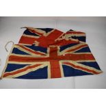 Two Union flags, the first 173cm x 82cm, the second a larger printed similar (2)