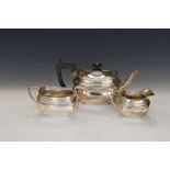 George VI silver three piece tea service comprising: teapot, two handled sugar basin and milk jug,