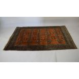 Three machine made Eastern-style wool rugs, one with rust-coloured ground, 125cm x 194cm, another