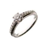 Unmarked white metal and diamond ring, the central brilliant cut stone measuring approximately 0.2ct