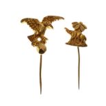 Two unmarked yellow metal stickpins, one cast with an elephant beneath a palm tree, the other a bird