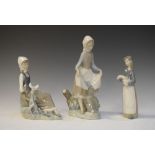 Three Lladro porcelain figures, girl with rabbit, girl with dove and girl with pig, the first 22.5cm