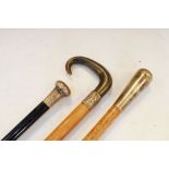 Three assorted silver-mounted walking sticks or canes, to include one with horn crook handle, a