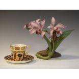 Royal Crown Derby coffee cup and saucer in Imari pattern, together with a porcelain flower study