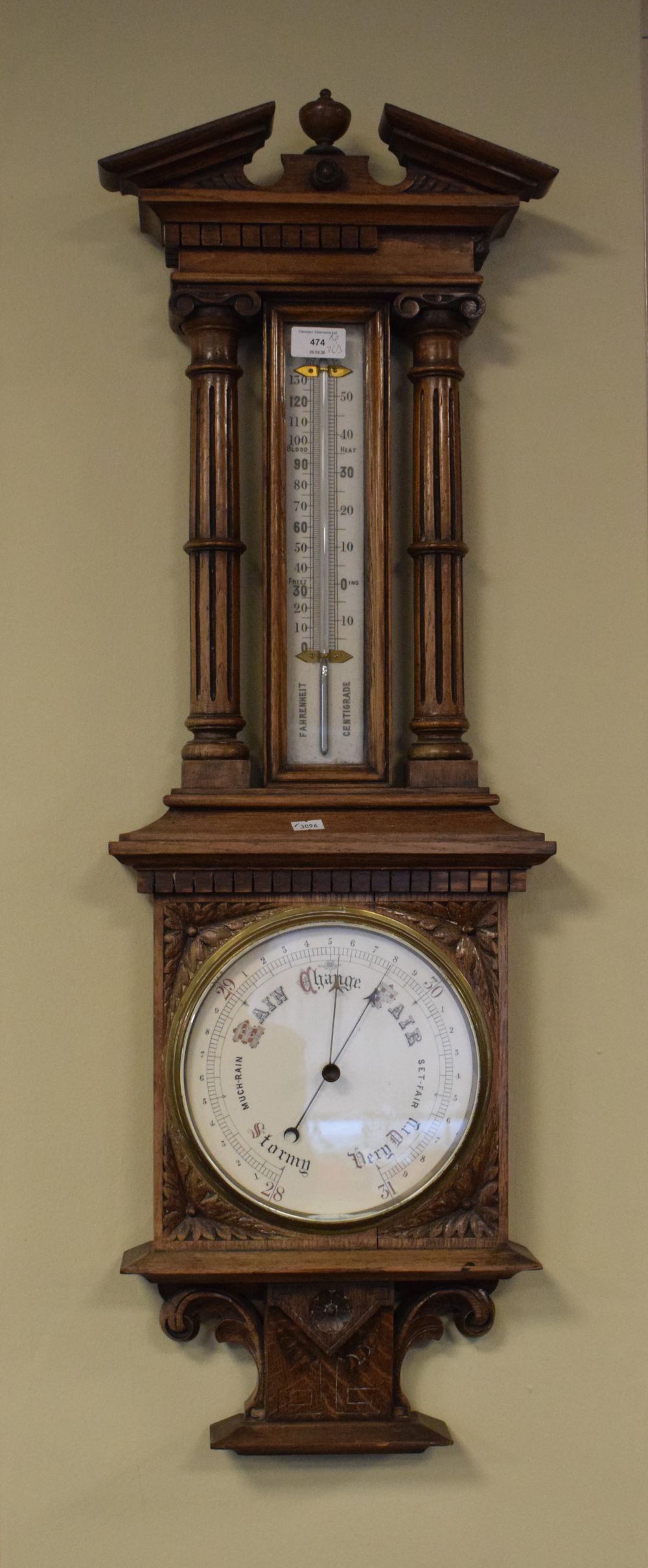 Late 19th/early 20th Century oak cased barometer having ceramic register plates and with mercury