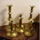 Set of four George III brass candlesticks, each having spreading oval base, 14.5cm high, together