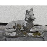 Reconstituted garden ornament modelled as a reclining Alsatian or German Shepherd, 48cm wide