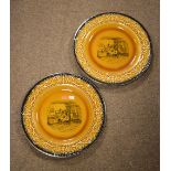 Pair of Crown Devon transfer-printed amber glazed plates, 34cm diameter