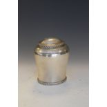 George V silver tea caddy of shouldered oval form with domed hinged cover, gadrooned rim and foot,