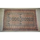 Two early to mid 20th Century Middle Eastern prayer rugs, each in terracotta colours with pairs of