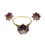 Yellow metal, diamond and ruby cluster ring of flowerhead design with central diamond and six