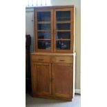 Early 20th Century oak and beech two section bookcase, the upper section fitted two glazed doors