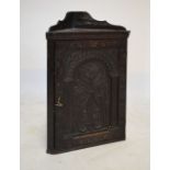 Late 19th/early 20th Century carved oak corner cupboard in the 17th Century taste, the hinged door