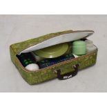 1960's period vintage picnic set having two Thermos flasks, plates and containers within a green