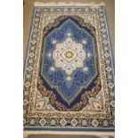 Two machine-made wool rugs, one with ivory ground and allover foliage, label verso 'Kirman-Shah',
