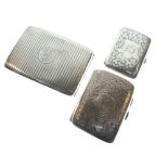 Silver cigarette case with engine turned decoration and two other silver cigarette cases with