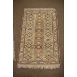 Two Middle Eastern Kilim rugs, one decorated with figures and animals on a green ground, 85cm x