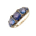 Late Victorian 18ct gold and five stone ring, set five graduated blue stones within scroll