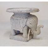 Painted wicker occasional table having oval detachable tray on an elephant design stand, 55cm high