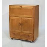 Ercol - Golden Dawn elm cabinet with fall front over a pair of cupboard doors and single drawer to