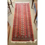 Middle Eastern wool runner, the field with brick-red and cobalt blue lattice decoration between