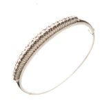 Diamond set hinged bangle, in 18ct white gold, the graduated stones totalling approximately 0.8