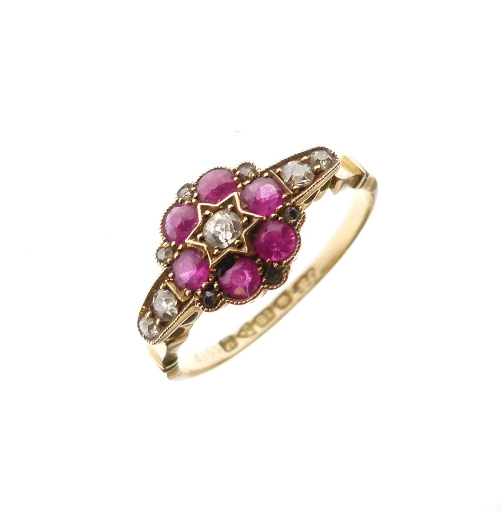 George V 18ct gold, ruby and diamond cluster ring of flowerhead design with central diamond, six