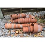 Approximately fifty terracotta garden pots, largest 16cm high