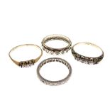 Four assorted rings to include; a yellow metal eternity ring stamped 9ct, unmarked eternity ring