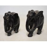 Pair of carved hardwood ebonised elephants standing 34cm high