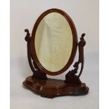 Victorian mahogany swing dressing mirror, the plain oval plate within moulded frame between