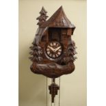 Mid 20th Century carved wooden cuckoo clock with Christmas tree decoration and pine cone weights,