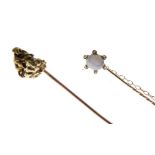 Stickpin set moonstone with white stone border, together with yellow metal nugget stickpin, both
