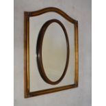 Serpentine top gilt framed mirror, 90cm high x 69cm wide, and a 1930's period oak framed oval mirror