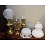 Five various oil lamps and shades