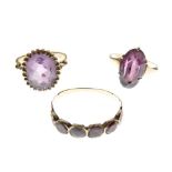Three assorted gold and yellow metal rings, each set amethyst-coloured stones, comprising two