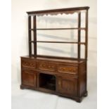 Antique oak dresser and rack, parts 18th Century, with moulded cornice and wavy valance over three