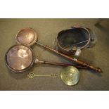 Copper helmet shaped coal bucket, two copper warming pans, and a brass cream skimmer