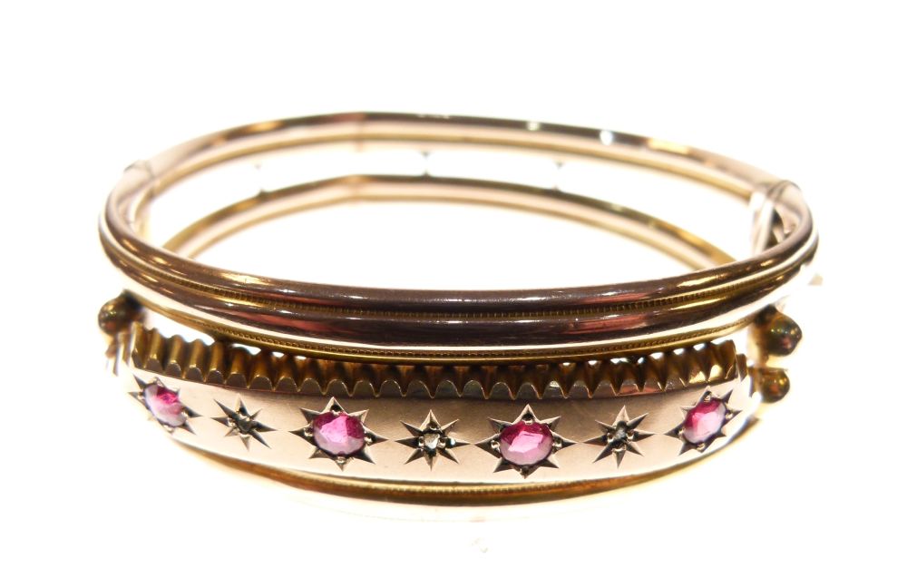 Edwardian 9ct rose gold snap bangle set a central band of red stones and diamond points, 12.5g