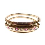 Edwardian 9ct rose gold snap bangle set a central band of red stones and diamond points, 12.5g