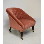 Victorian tub chair having pink button back upholstery, raised on turned walnut supports, fitted