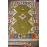 Two Middle Eastern (South Caucasian) wool rugs, the larger decorated with animals within a figural