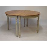 Pine scrub top circular table formed from two D-ends raised on painted turned supports, 124cm