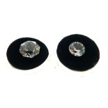 Two unmounted gem stones, circular plastic boxes state beneath 'Topaz 8.95 carats and 4.1 carats'