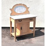 Late 19th/early 20th Century scrubbed pine marble top washstand having oval marble panel back with