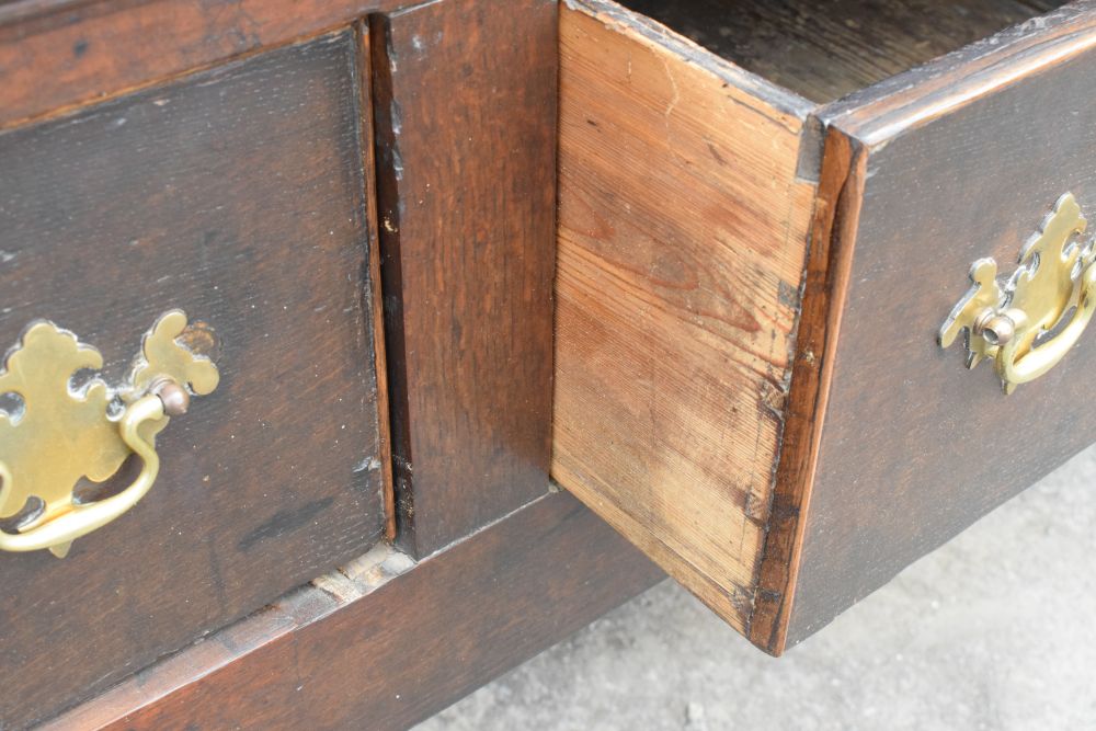 18th Century oak dresser base fitted three drawers with brass swan neck handles, raised on turned - Image 4 of 8