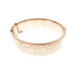 9ct gold snap bangle, one half externally having foliate scroll decoration, 18.5g approx