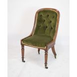 Victorian walnut button-back armchair raised on turned supports, upholstered in green fabric