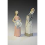 Lladro porcelain figure of a girl holding a sun hat, together with maid holding a sheep, 28cm high