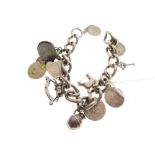 White metal curb link charm bracelet set with twelve assorted coins and charms plus padlock, stamped